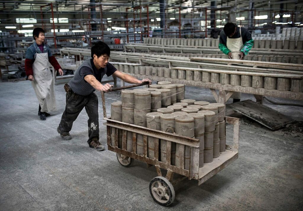 Ceramic production workshop in China with rows of ceramic products arranged on storage racks