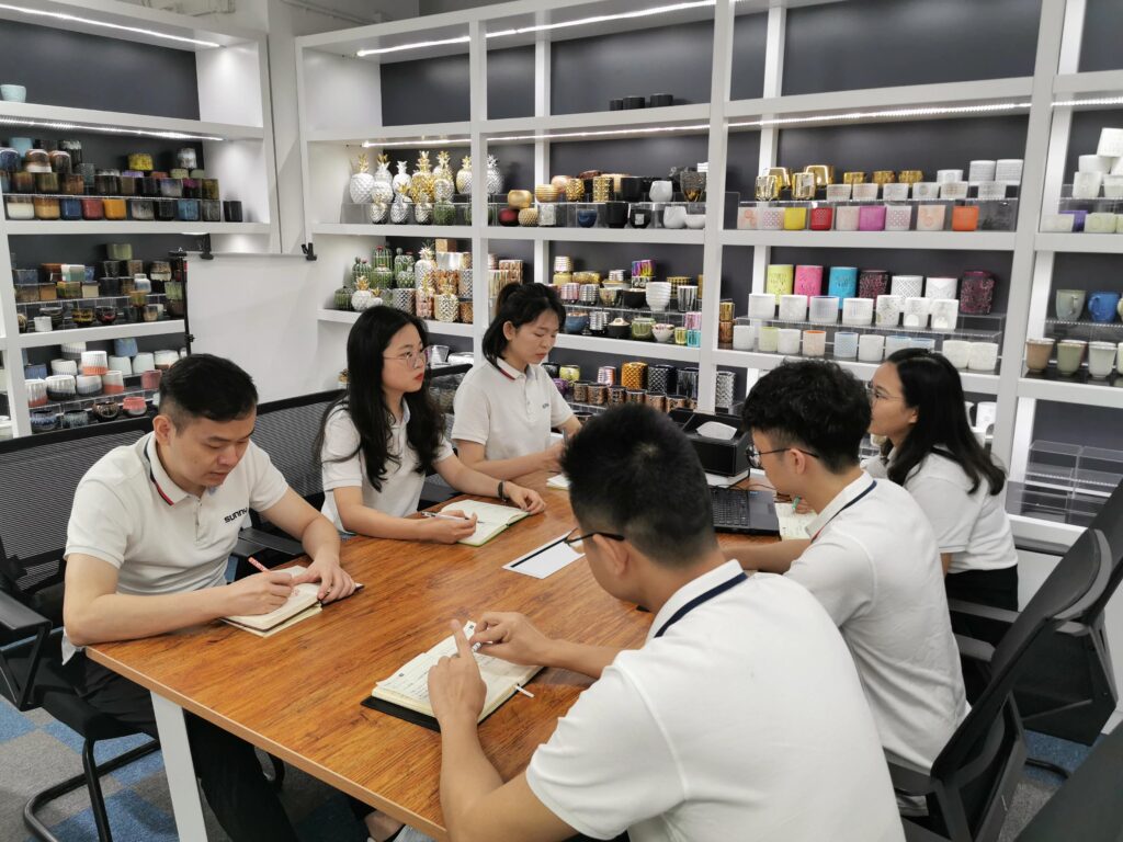 Ceramic home decor sourcing team reviewing products and buyer requirements